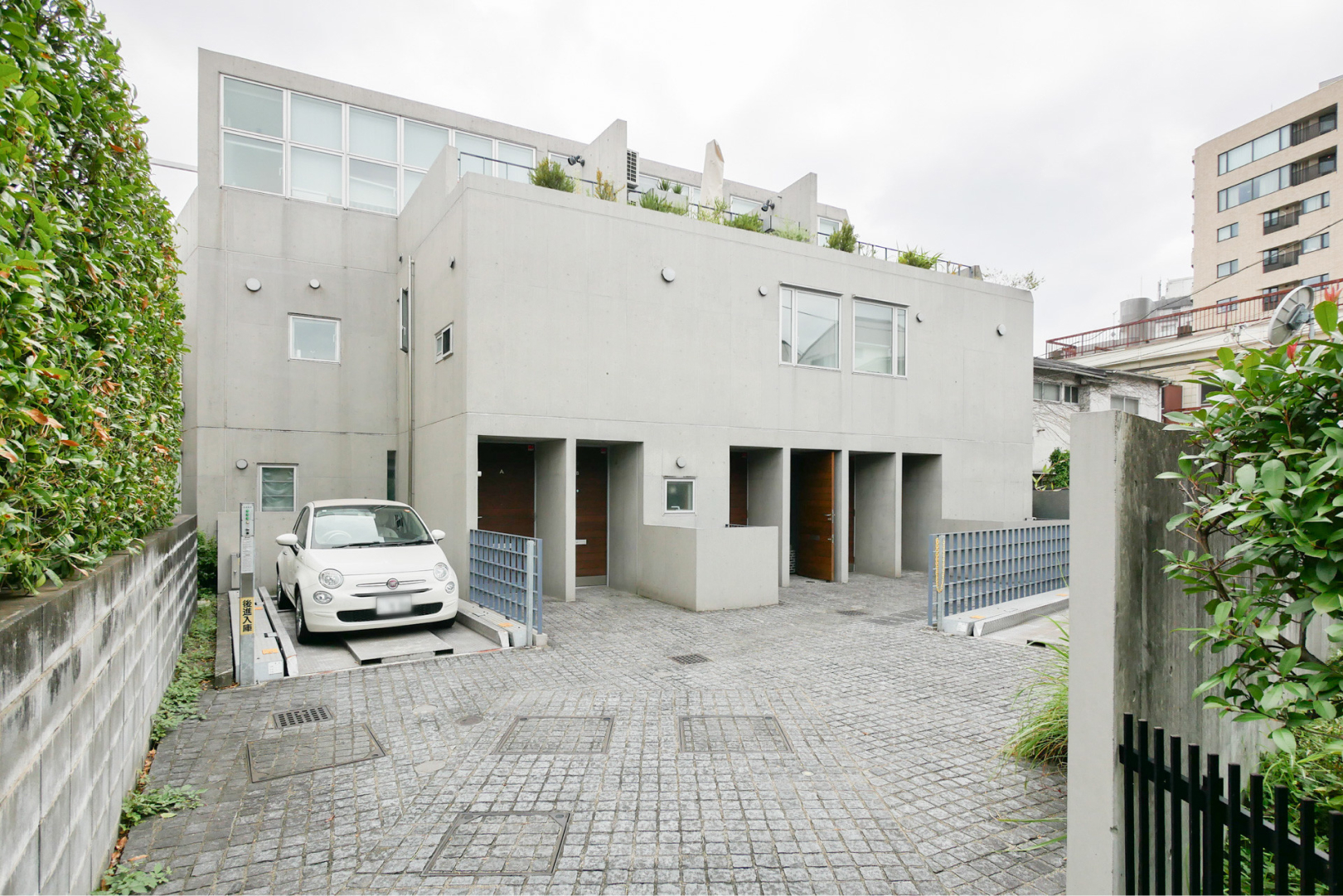 石張りの床にコンクリート打ち放しの外観、全住戸に専用駐車場がつきます。